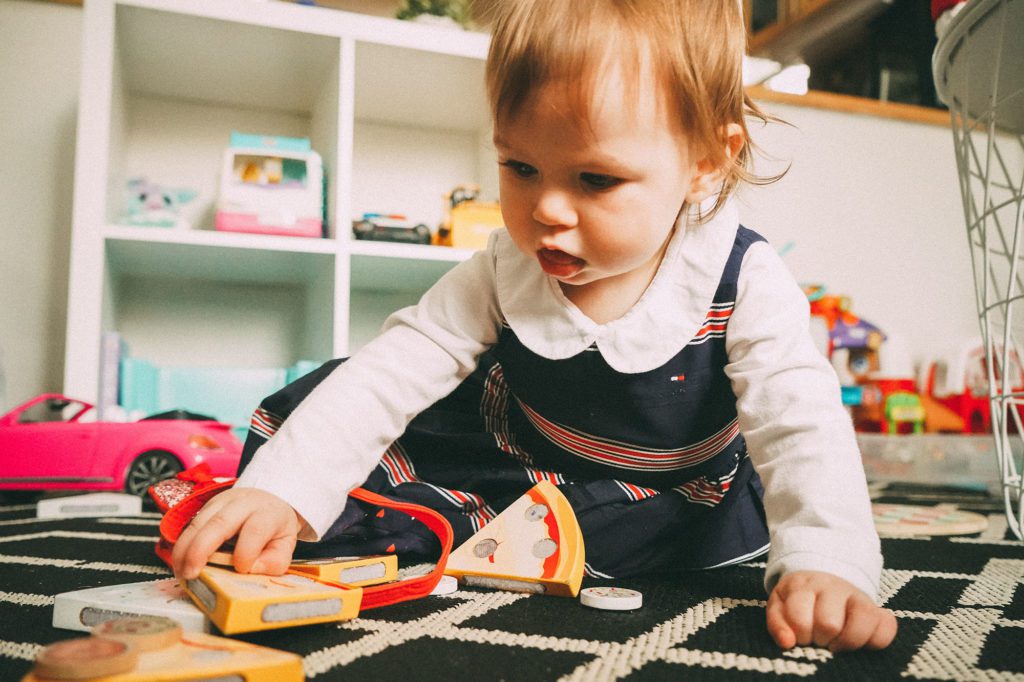 child playing with toys at home daycare